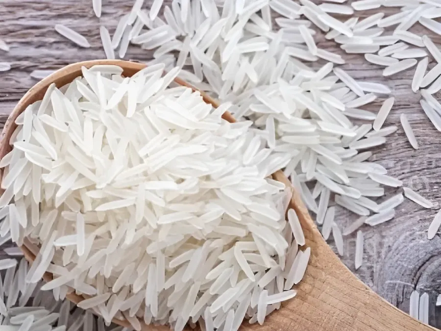 Long-grain white rice on a wooden spoon